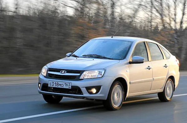 a lada granta driving on a road