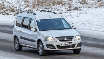 a lada largus driving on a snowy road